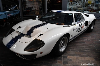 Image of a white sports car on show in a museum